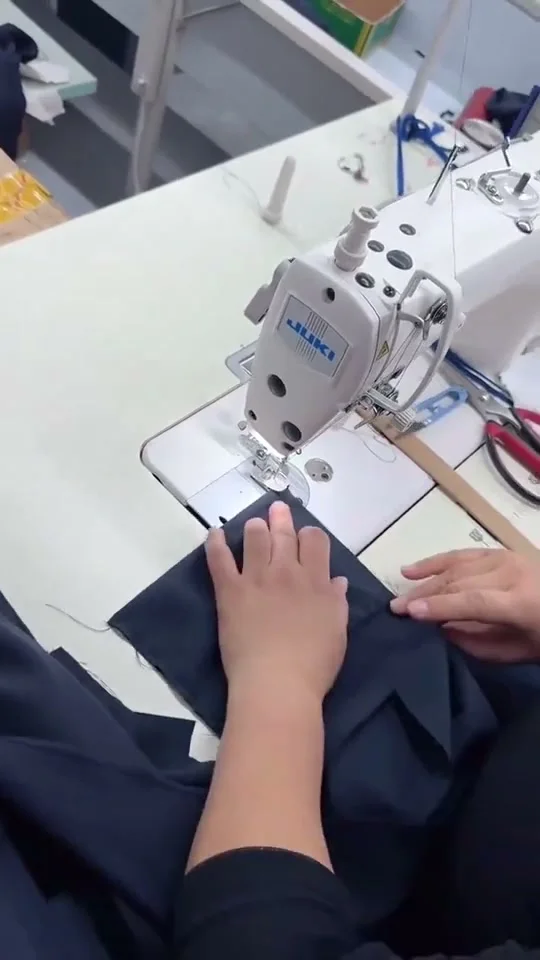 Garment sewing at a Workwear Solutions workshop station
